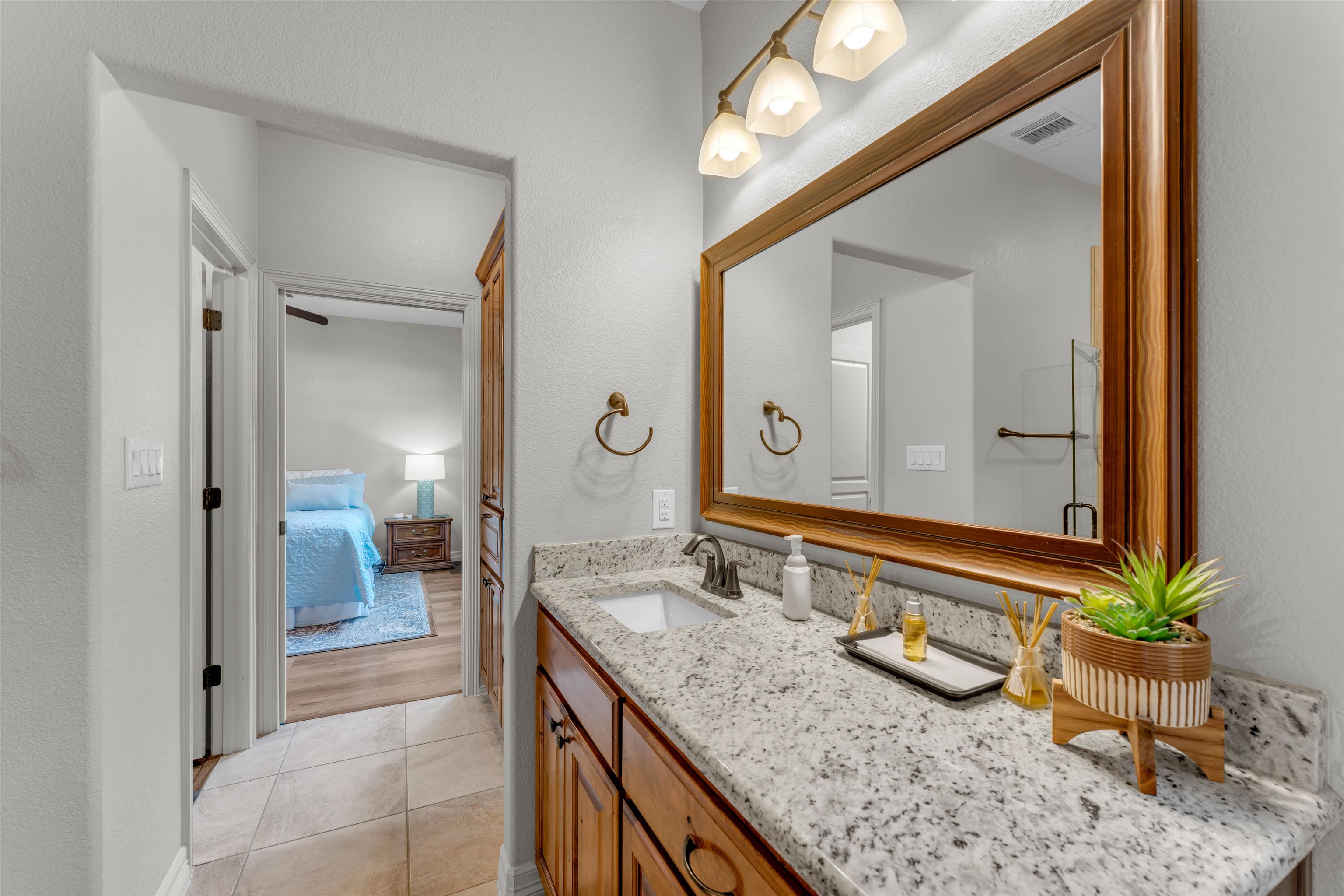 227 Watkins Point Kingsland, TX 78639 - Photo 13 of 30 a bathroom with a granite countertop sink and a mirror