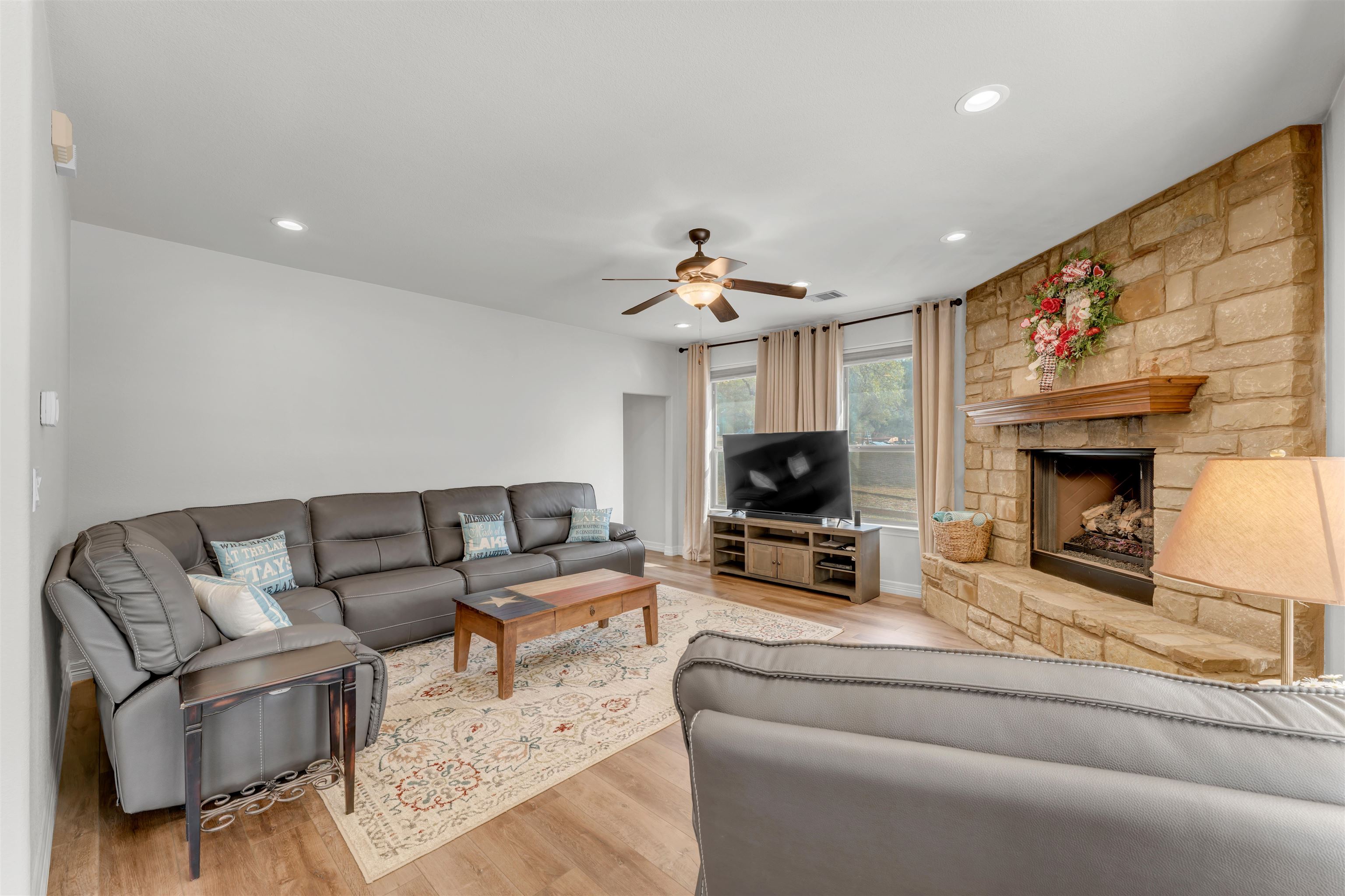 227 Watkins Point Kingsland, TX 78639 - Photo 15 of 30 a living room with furniture a fireplace and a flat screen tv