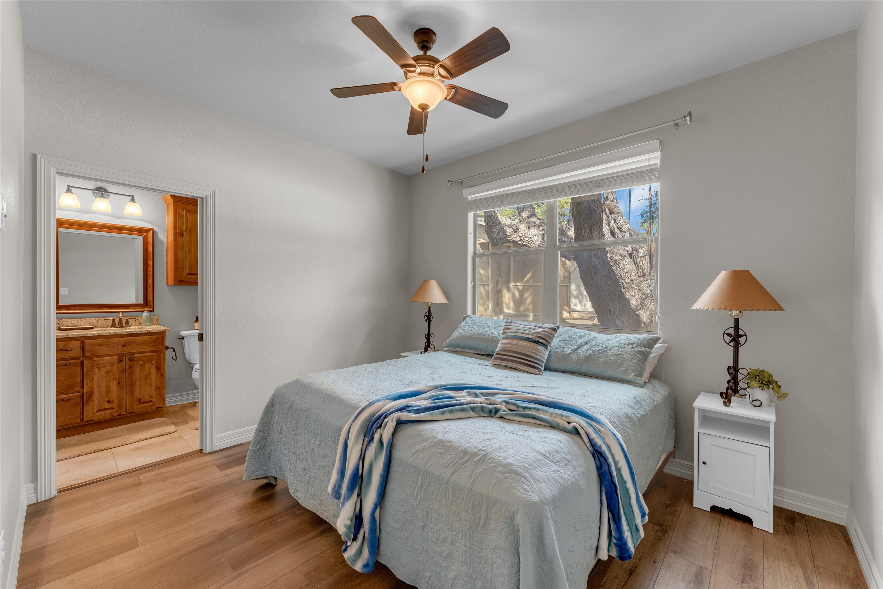 227 Watkins Point Kingsland, TX 78639 - Photo 18 of 30 a bed sitting in a bedroom next to a window