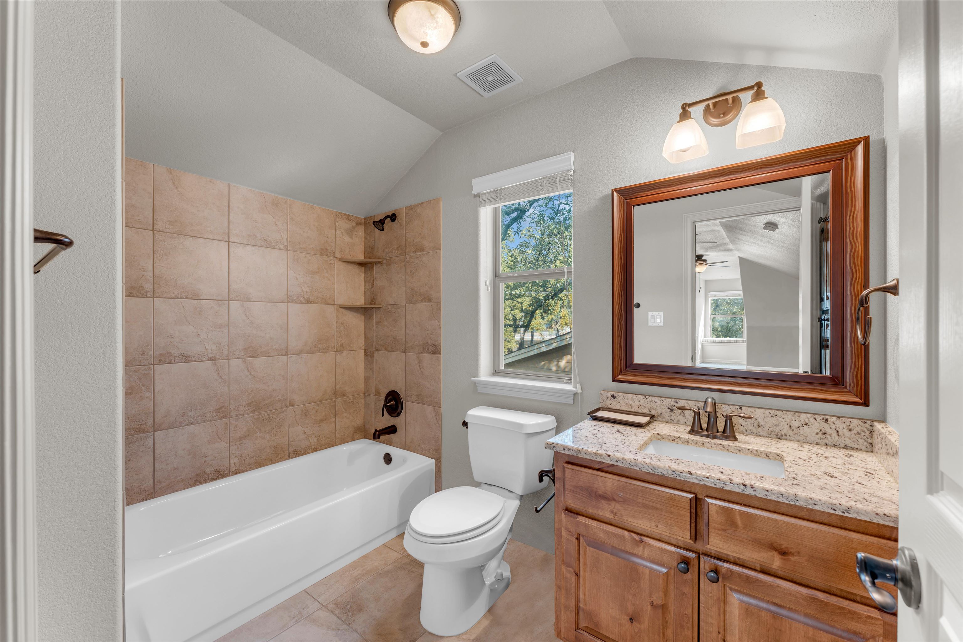 227 Watkins Point Kingsland, TX 78639 - Photo 21 of 30 a bathroom with a granite countertop sink a toilet and bathtub