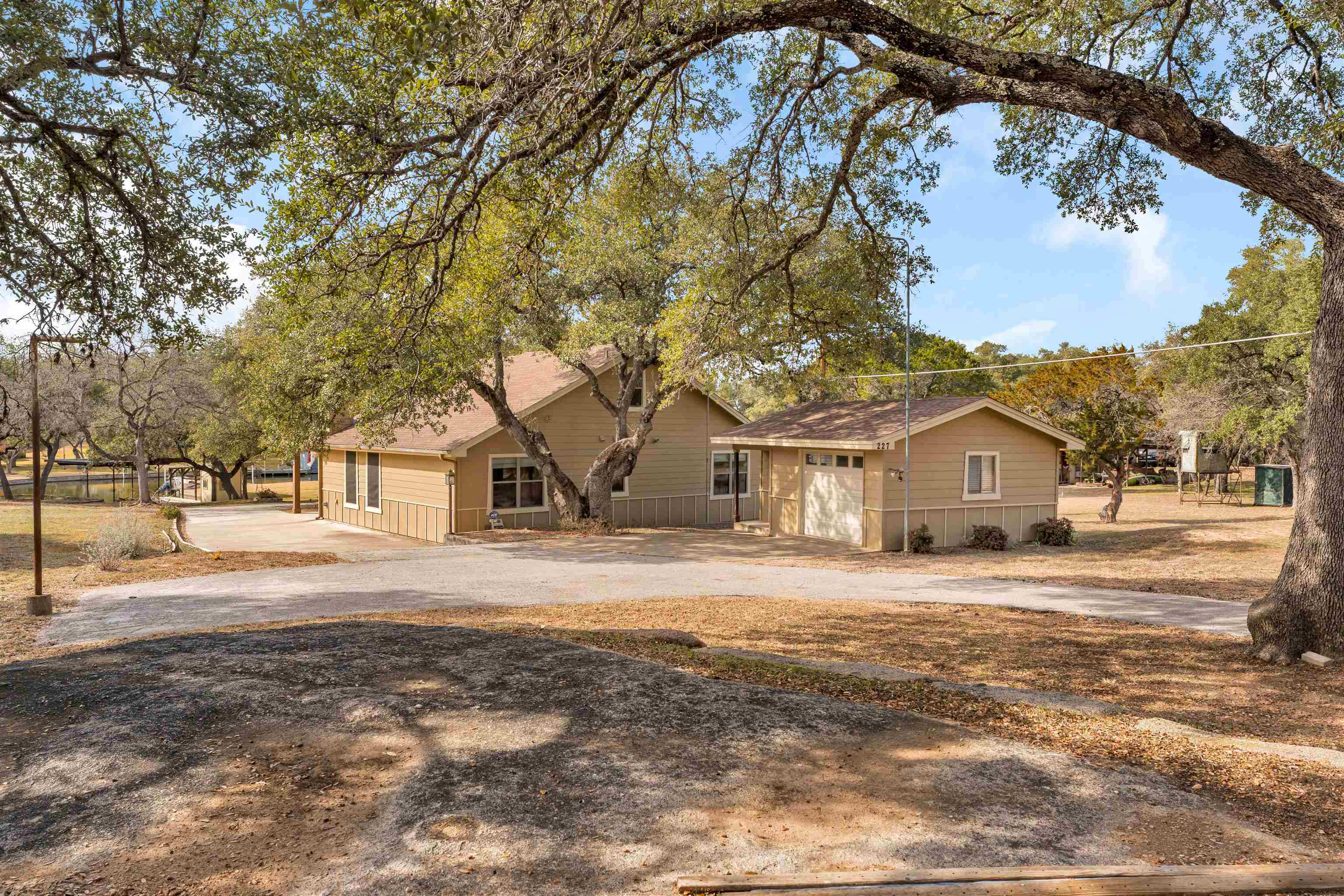 227 Watkins Point Kingsland, TX 78639 - Photo 4 of 30 a front view of a house with a yard covered with snow