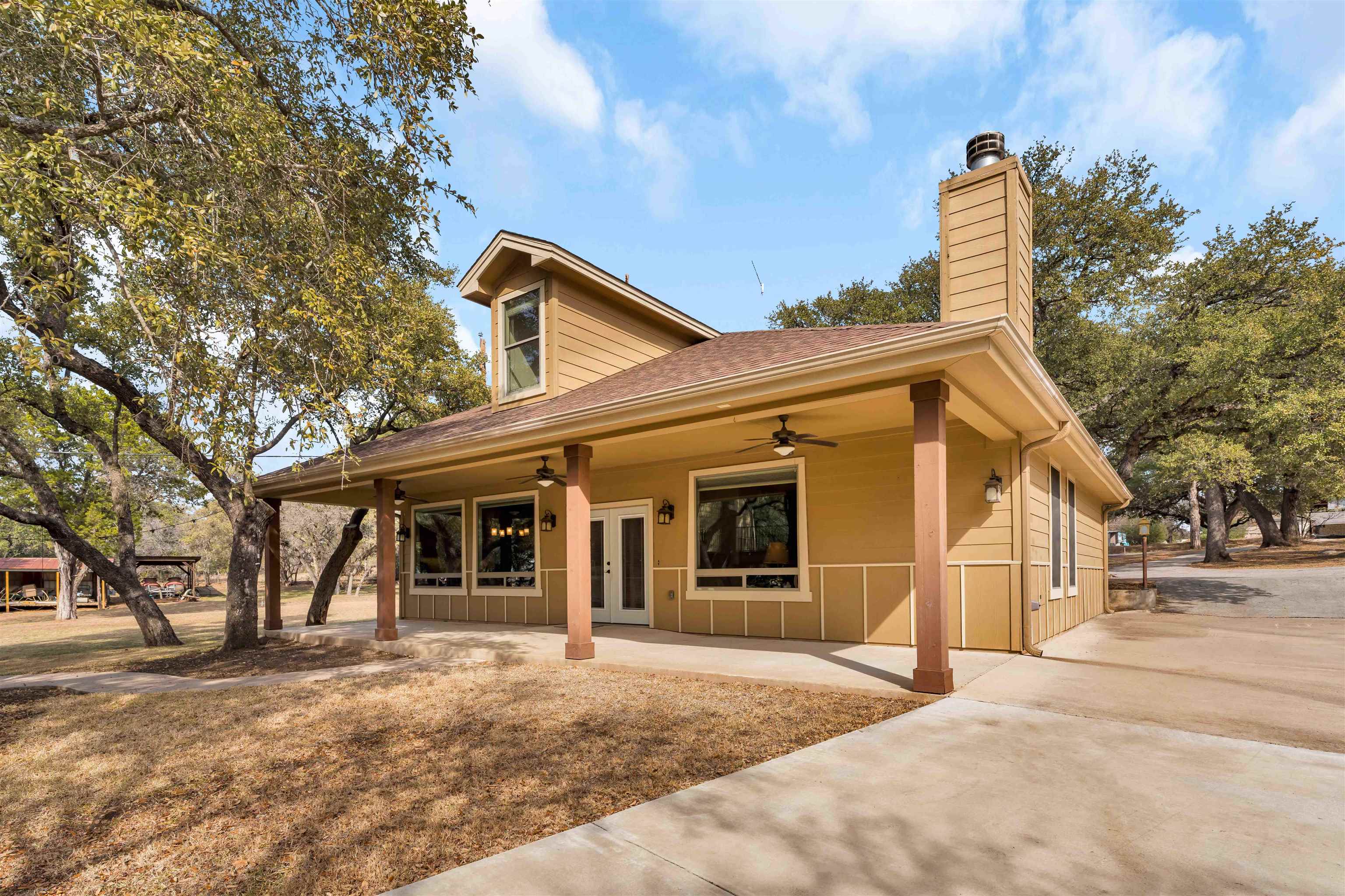 227 Watkins Point Kingsland, TX 78639 - Photo 6 of 30 a front view of a house with a yard and garage
