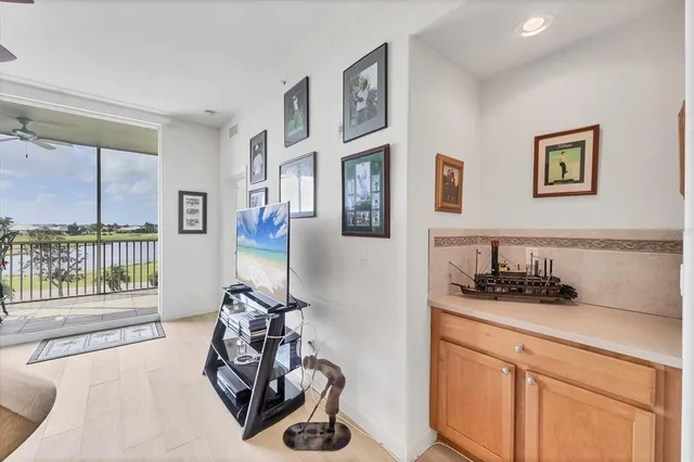a kitchen with stainless steel appliances a table and chairs in it