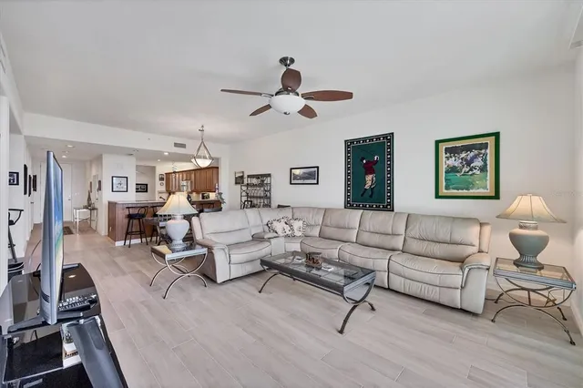 a kitchen with stainless steel appliances granite countertop a table chairs and a refrigerator