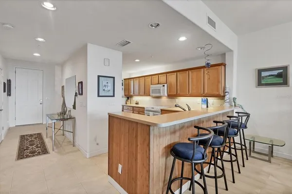 a kitchen with stainless steel appliances a refrigerator sink and cabinets