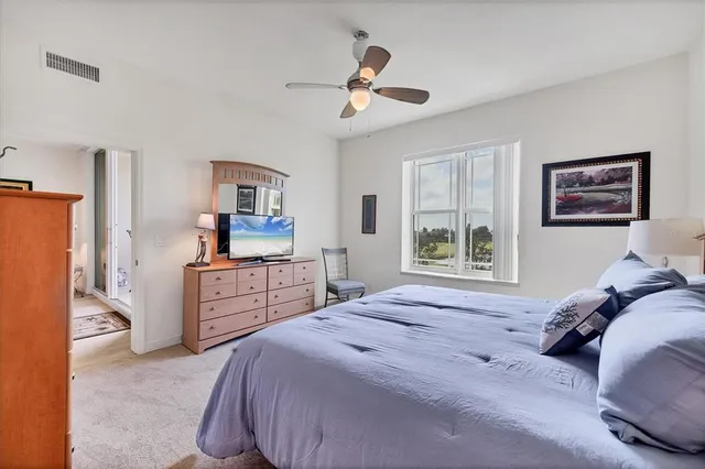 a bedroom with two beds and windows