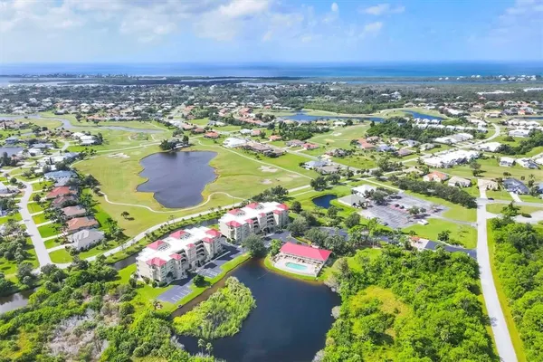 an aerial view of residential houses with outdoor space and swimming pool