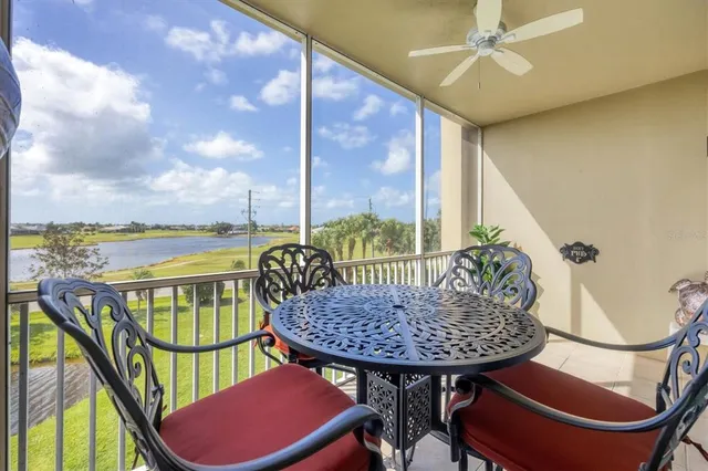 an aerial view of a house with a garden and lake view