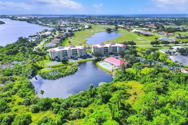 a view of a lake with a swimming pool outdoor seating and yard