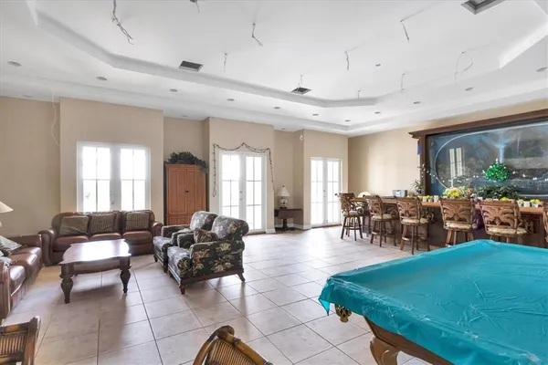 a view of a swimming pool with a garden and trees
