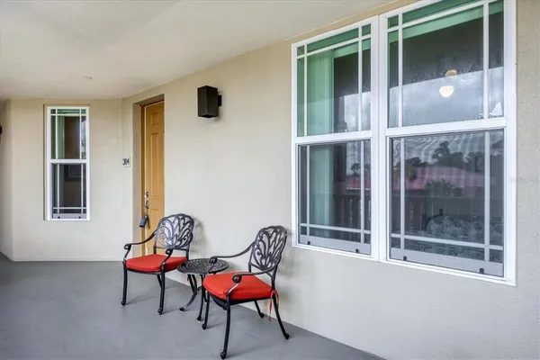 a living room with furniture a floor to ceiling window and a flat screen tv