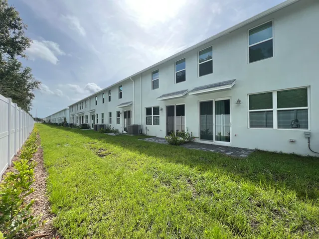 a swimming pool with outdoor seating and yard