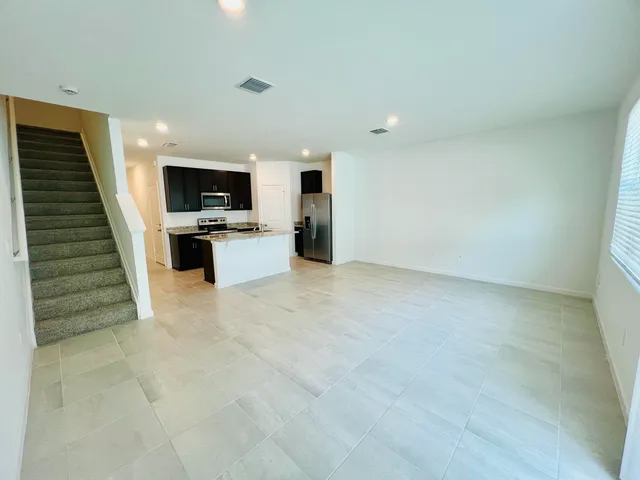 a view of kitchen and kitchen with microwave
