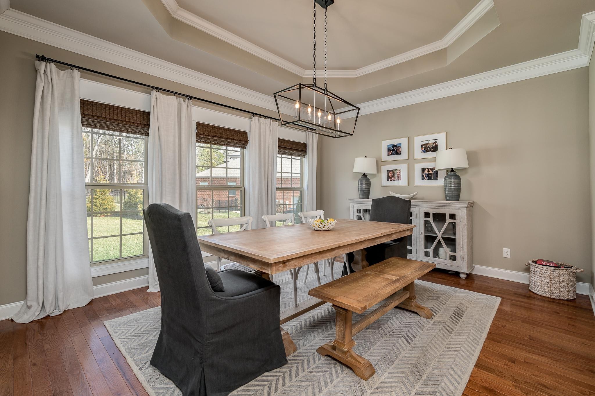 640 Twin View Drive Murfreesboro, TN 37128 - Photo 10 of 33 a dining room with wooden floor a chandelier a wooden table and chairs