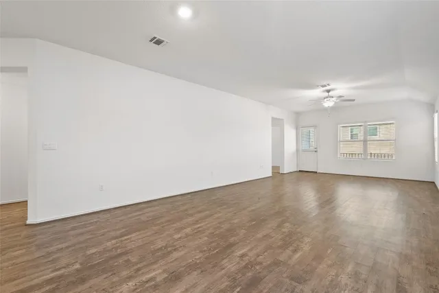 a kitchen with a sink cabinets and wooden floor
