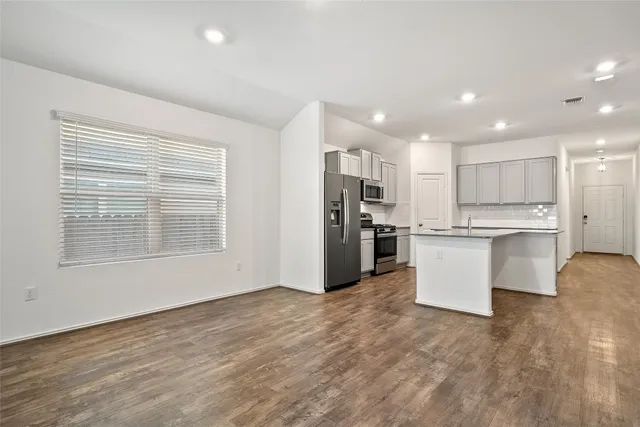 a view of a room with a ceiling fan