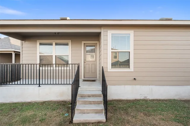 a view of a balcony with wooden floor and fence