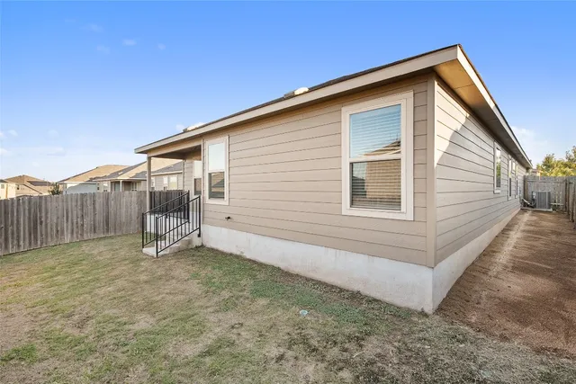 a view of a house with wooden fence