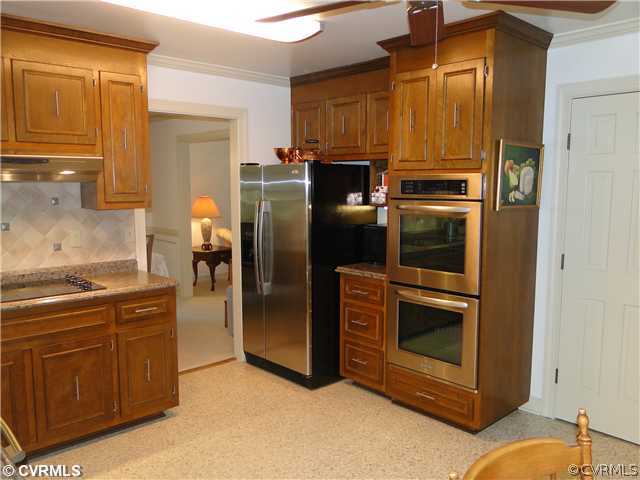 12811 Singer Road Midlothian, VA 23112 - Photo 3 of 12 a kitchen with stainless steel appliances granite countertop a refrigerator and a stove