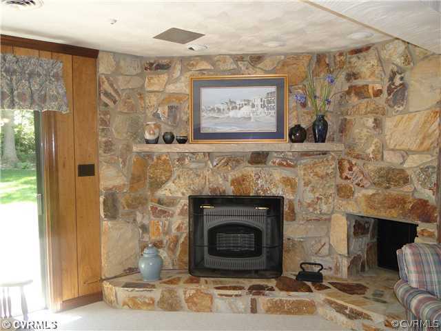 12811 Singer Road Midlothian, VA 23112 - Photo 7 of 12 a stone fireplace with a mirror