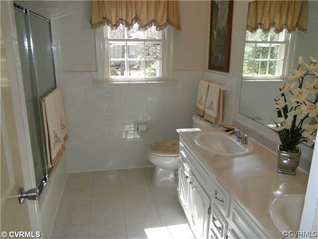 12811 Singer Road Midlothian, VA 23112 - Photo 9 of 12 a bathroom with a sink a toilet and a mirror
