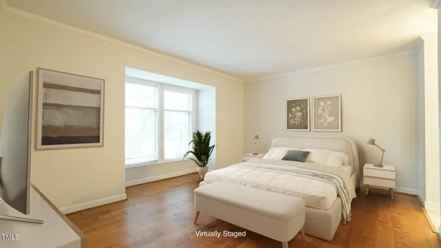 a bedroom with a large bed and a window