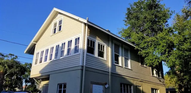 a front view of a house with a trees