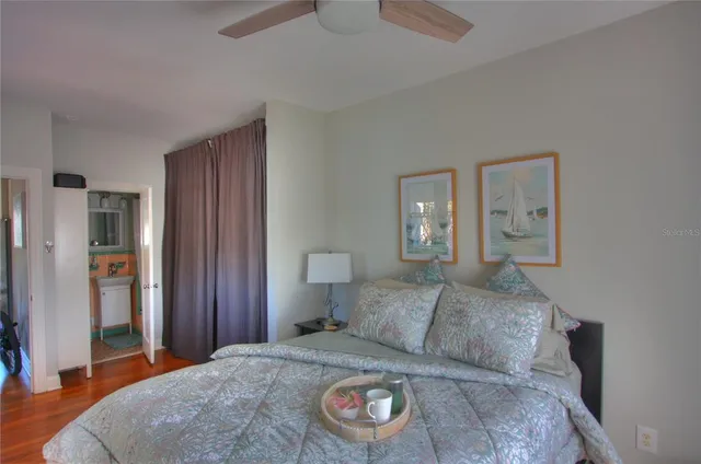 a bedroom with a bed and a lamp on dresser