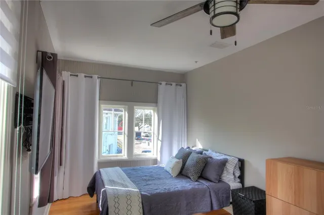 a bedroom with a bed and a window