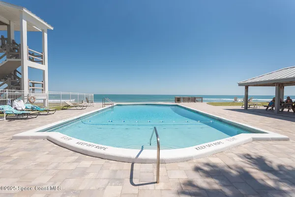 a view of a swimming pool with a lounge chairs