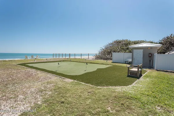 a view of a swimming pool with a yard