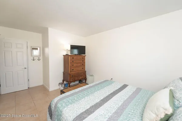 a bedroom with a bed and a television
