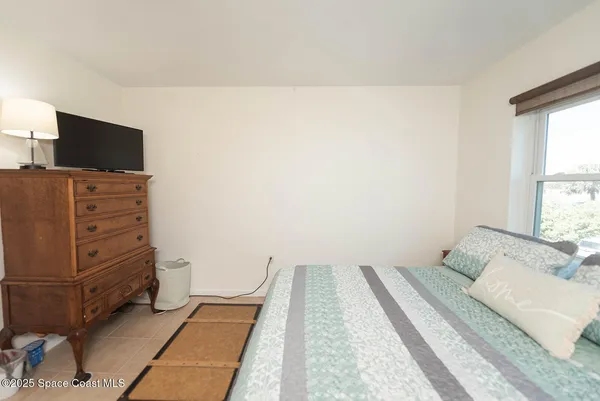 a bedroom with a bed and flat screen tv