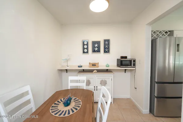 a kitchen with a refrigerator and a stove top oven