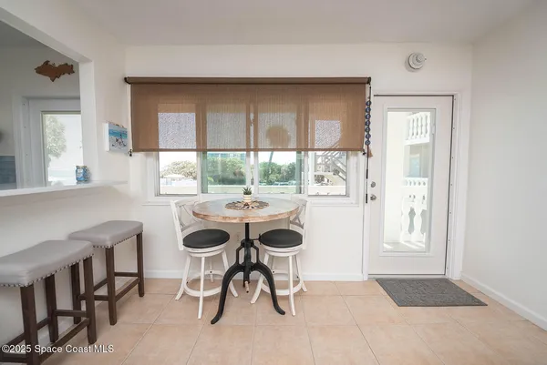 a view of a dining room with a table and chairs