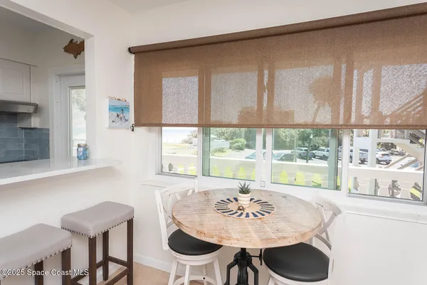 a view of a dining room with furniture window and outside view