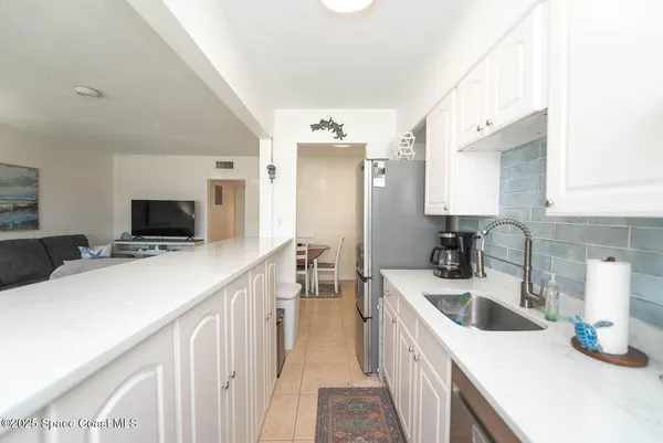 a kitchen with a sink and a refrigerator