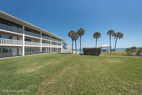 a house with palm tree in front of it