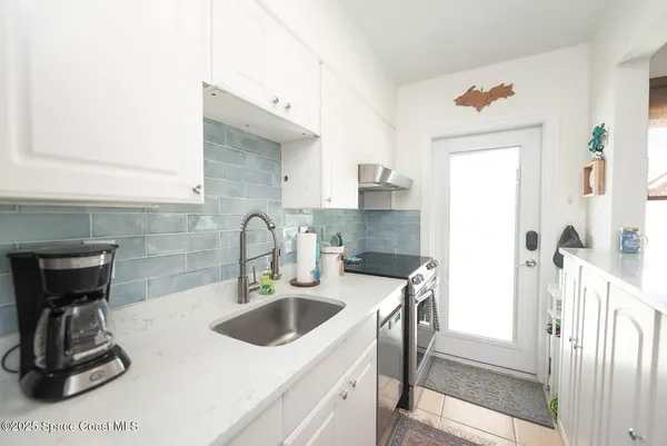 a kitchen with a sink cabinets and appliances