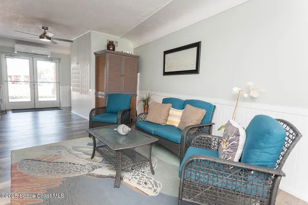 a living room with furniture and wooden floor