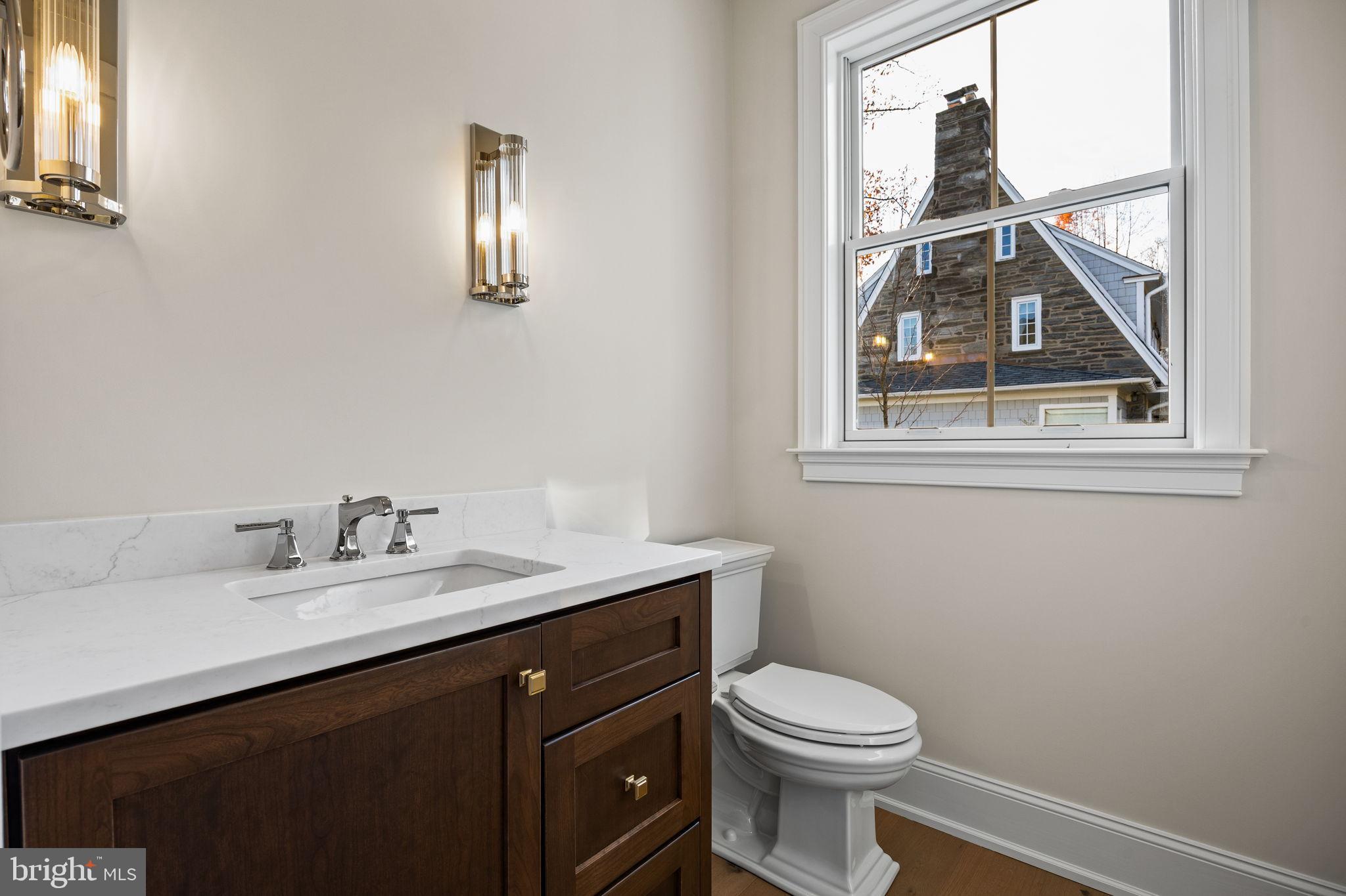 16 Fariston Road Wayne, PA 19087 - Photo 16 of 106 a bathroom with a toilet a sink a vanity and mirror