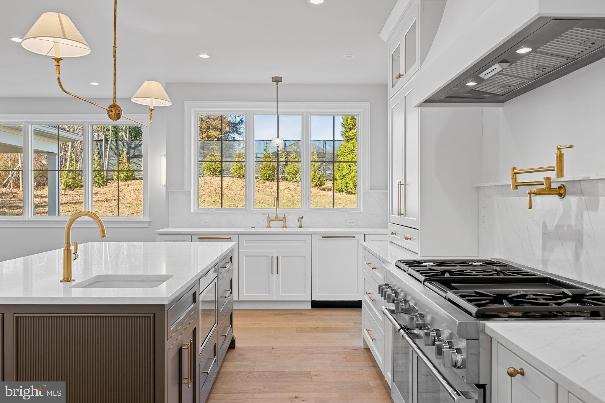 16 Fariston Road Wayne, PA 19087 - Photo 33 of 106 a kitchen with granite countertop a sink stove and cabinets