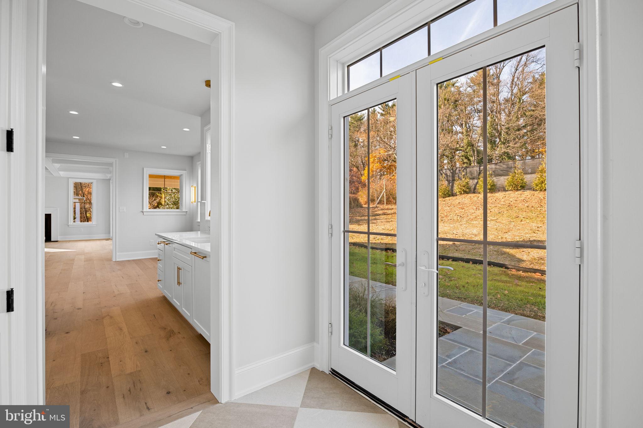 16 Fariston Road Wayne, PA 19087 - Photo 39 of 106 a view of a hallway with wooden floor and a living room