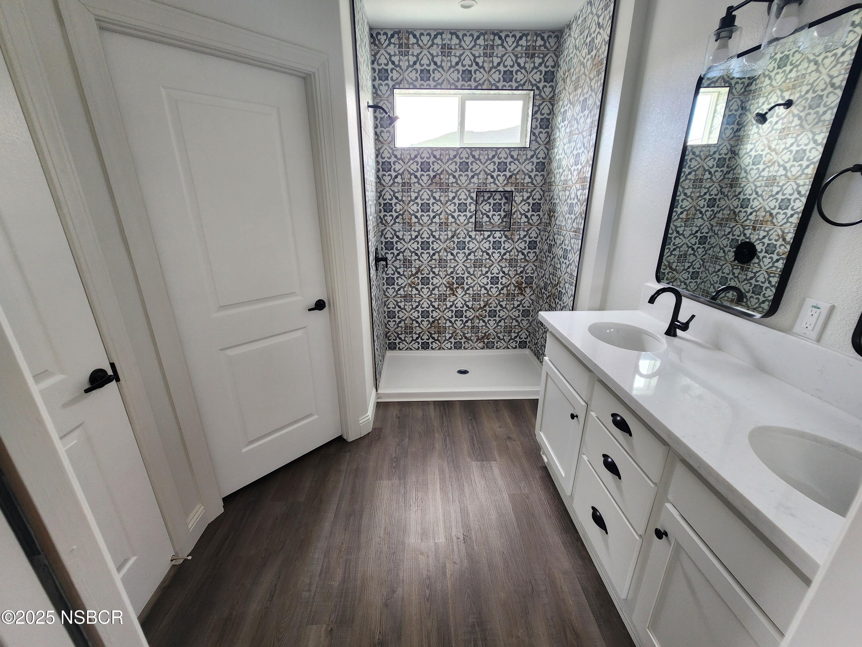 87 Rio Vista Solvang, CA 93463 - Photo 13 of 18 a bathroom with a sink a mirror and a shower