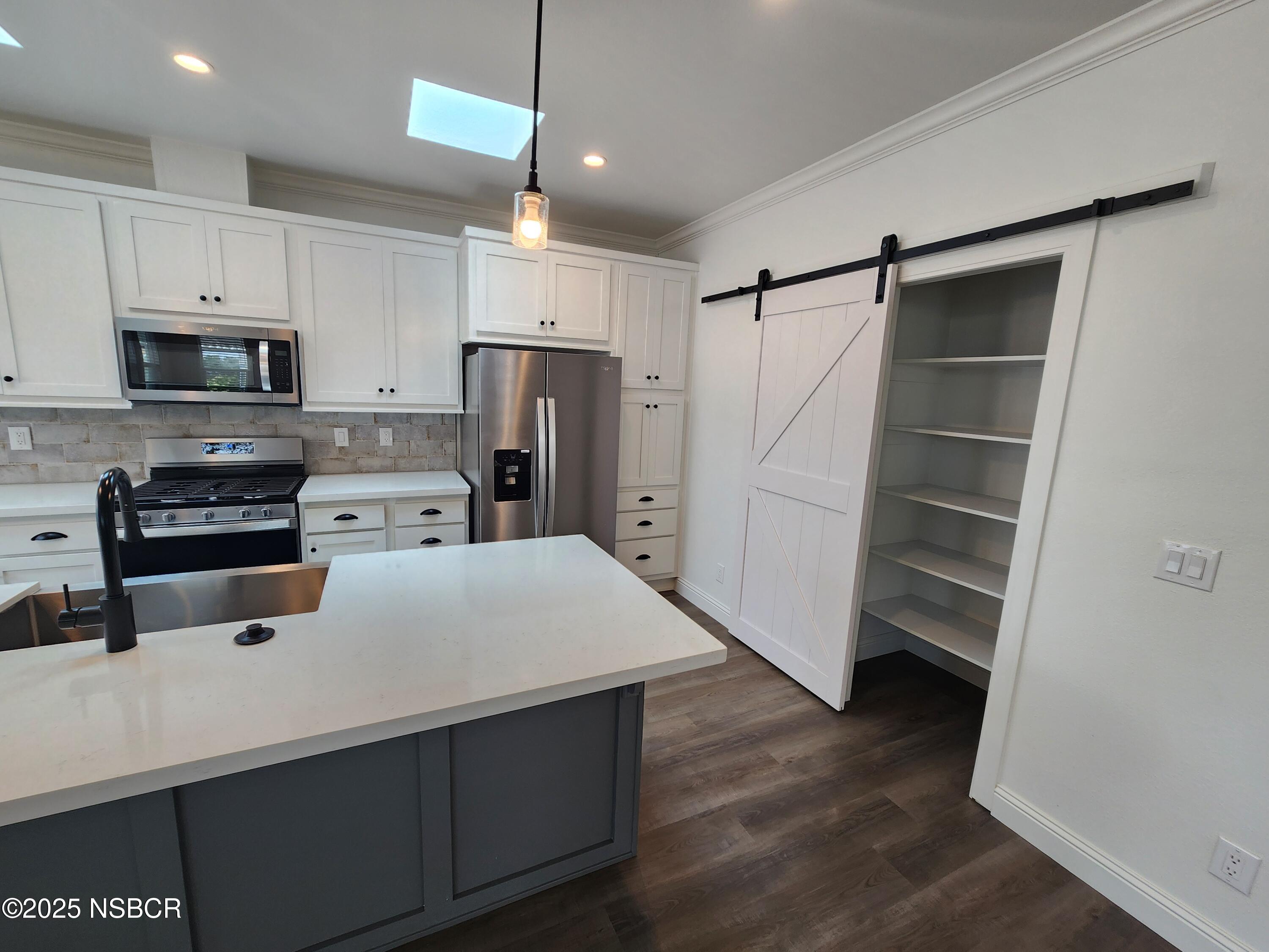 87 Rio Vista Solvang, CA 93463 - Photo 5 of 18 a kitchen with a refrigerator a stove top oven a sink and cabinets