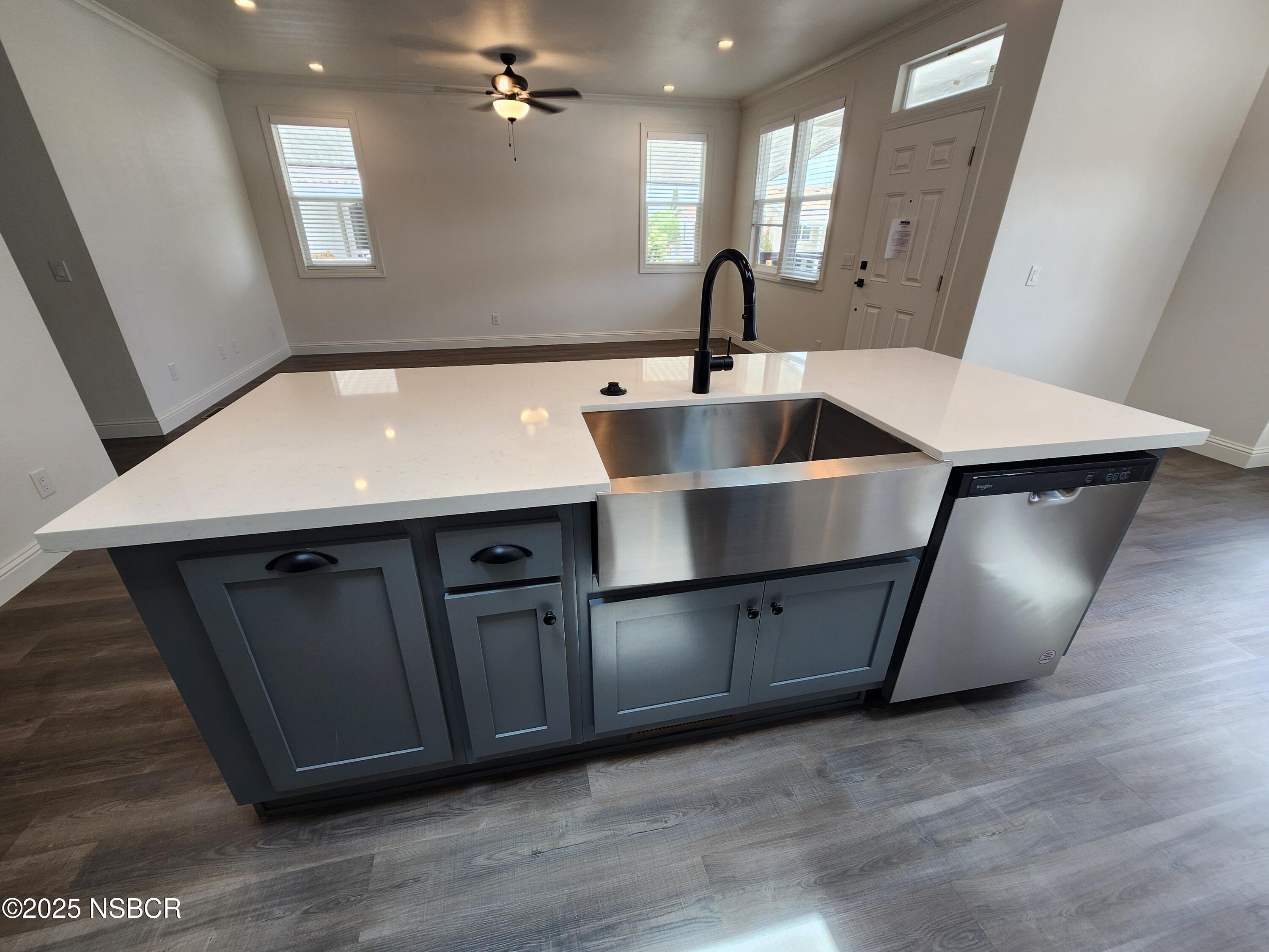 87 Rio Vista Solvang, CA 93463 - Photo 8 of 18 a kitchen with stainless steel appliances granite countertop a sink a refrigerator and wooden floor