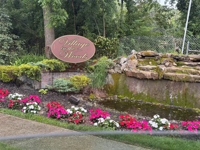 a view of a flower arrangement in backyard of a house