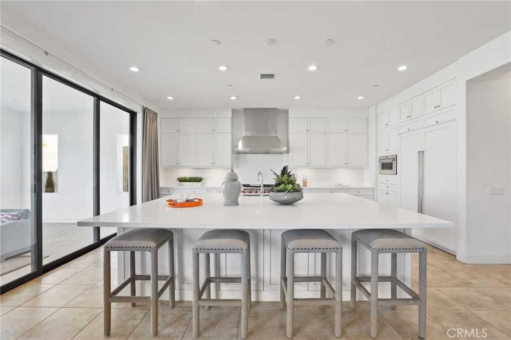 74 Egret Irvine, CA 92618 - Photo 16 of 74 a kitchen with stainless steel appliances dining table and chairs