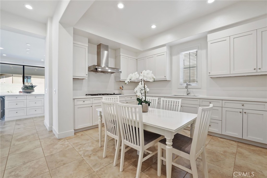 74 Egret Irvine, CA 92618 - Photo 23 of 74 a kitchen with a dining table chairs and cabinets