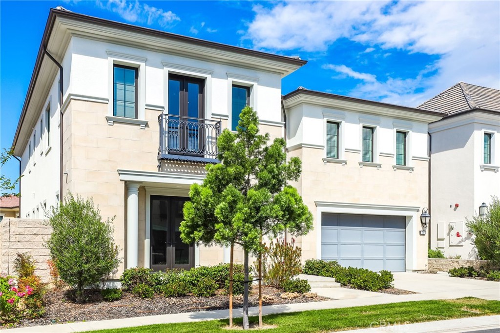74 Egret Irvine, CA 92618 - Photo 3 of 74 a front view of a house with a yard and garage